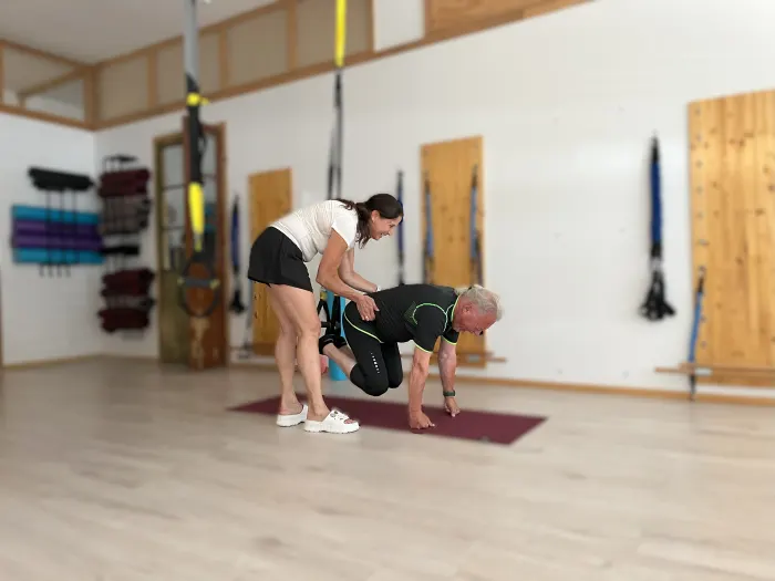 A physical therapist guiding a client through a rehab exercise